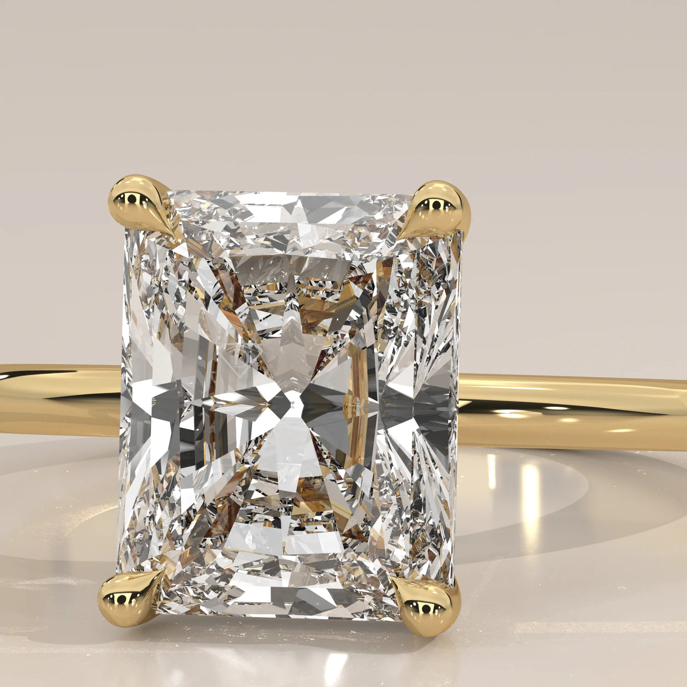 A radiant cut diamond engagement ring in 14k yellow gold.