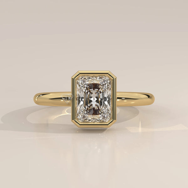 A yellow gold ring with a radiant cut diamond.