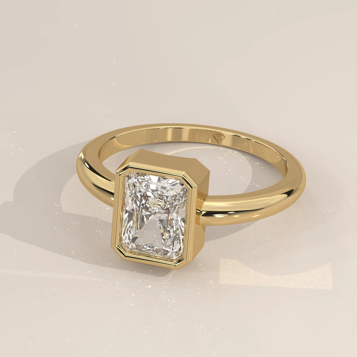 Gold ring with a radiant-cut diamond in a bezel setting.