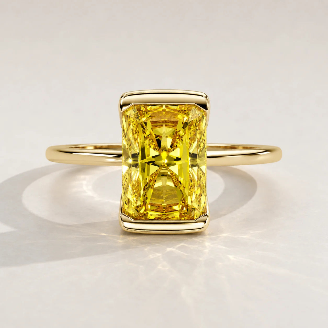A yellow radiant-cut diamond ring set in yellow gold.