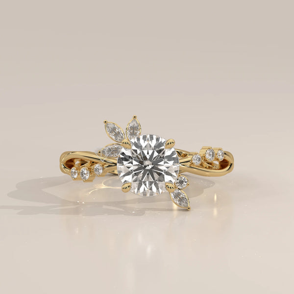 A delicate 14k gold ring featuring a round brilliant cut center stone with floral accents.