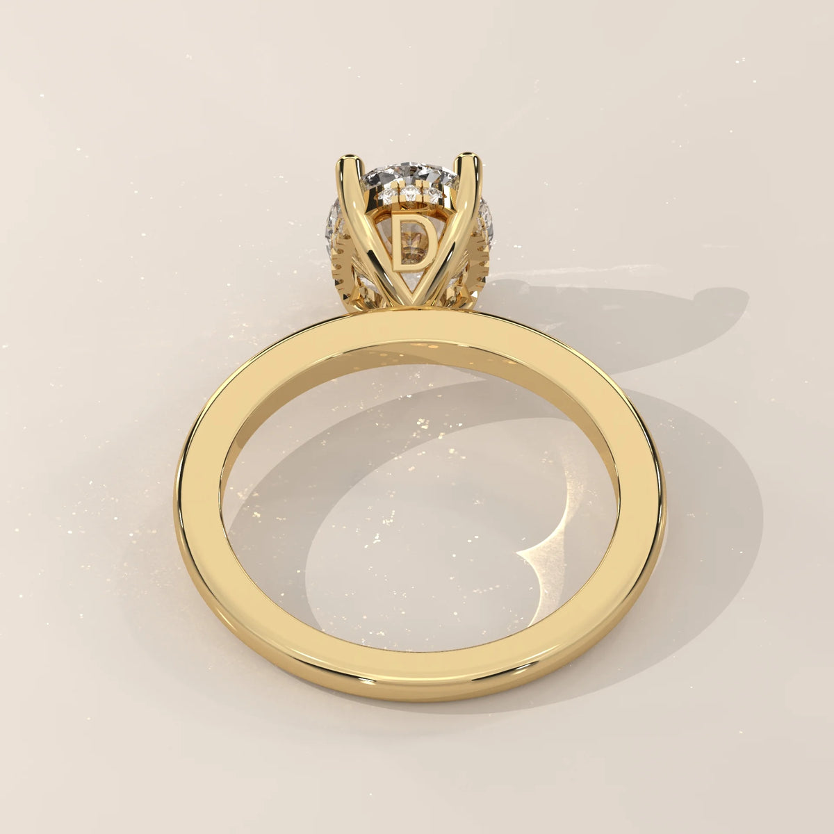 A close-up, back view of a 14k gold ring with a prominent diamond and halo.