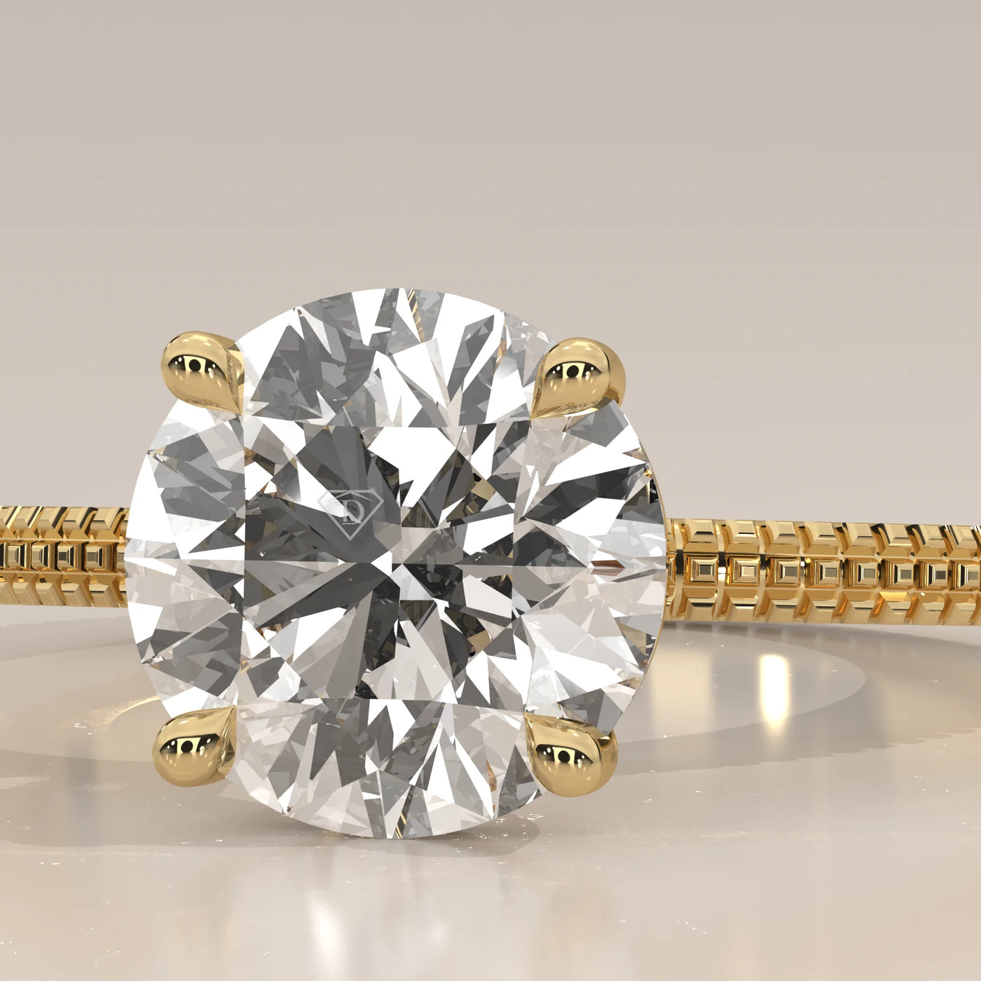 A solitaire diamond ring with a detailed gold band.