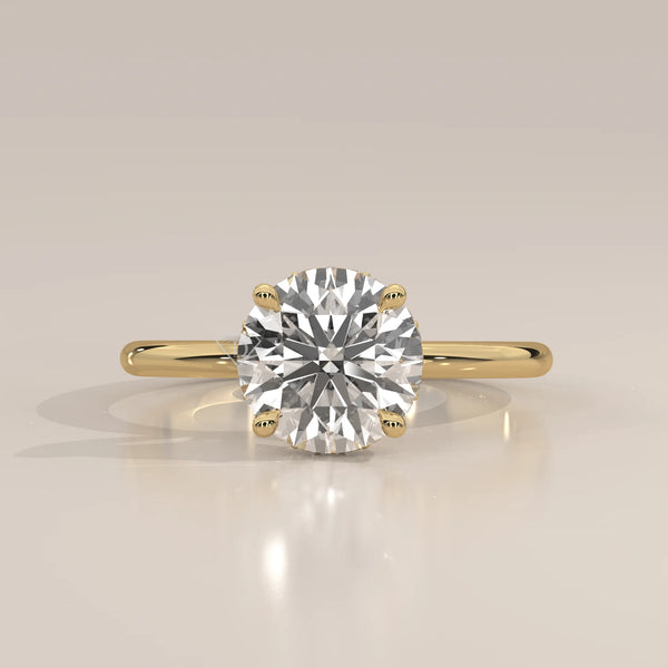 A classic solitaire diamond ring with a 14k gold band.