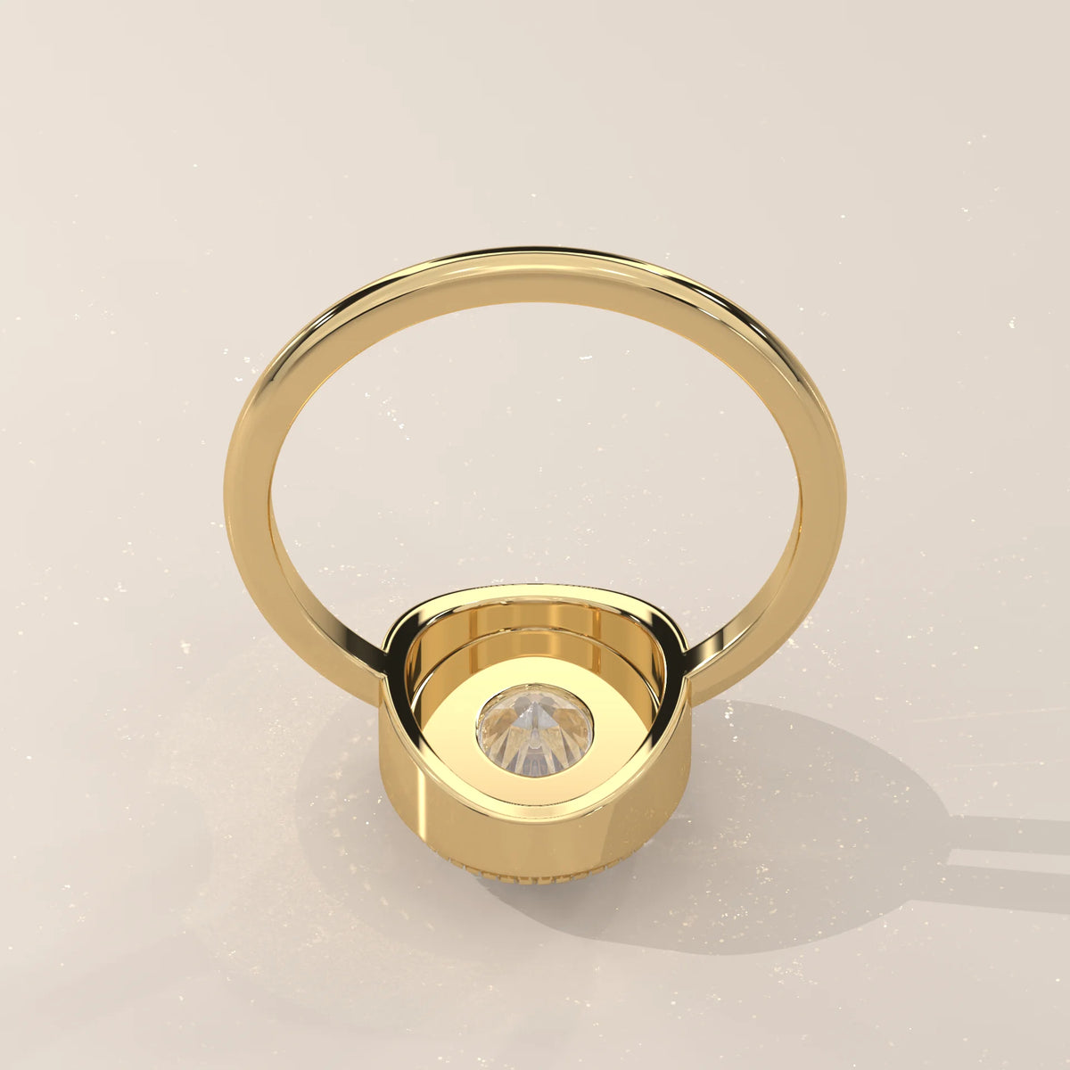 Oval Lab Grown Diamond Bezel Solitaire with Coin Edge Rim in yellow gold, viewed from overhead.