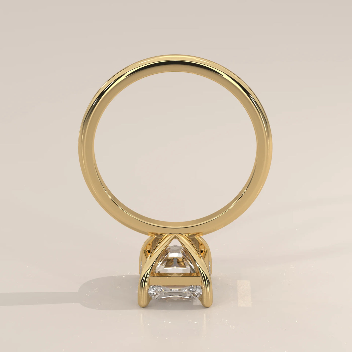 A square cut diamond engagement ring in polished yellow gold.