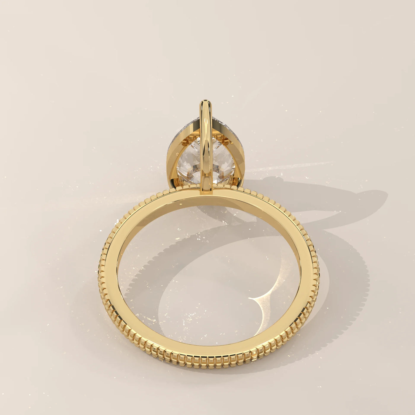 A yellow gold ring with a large pear-shaped diamond.