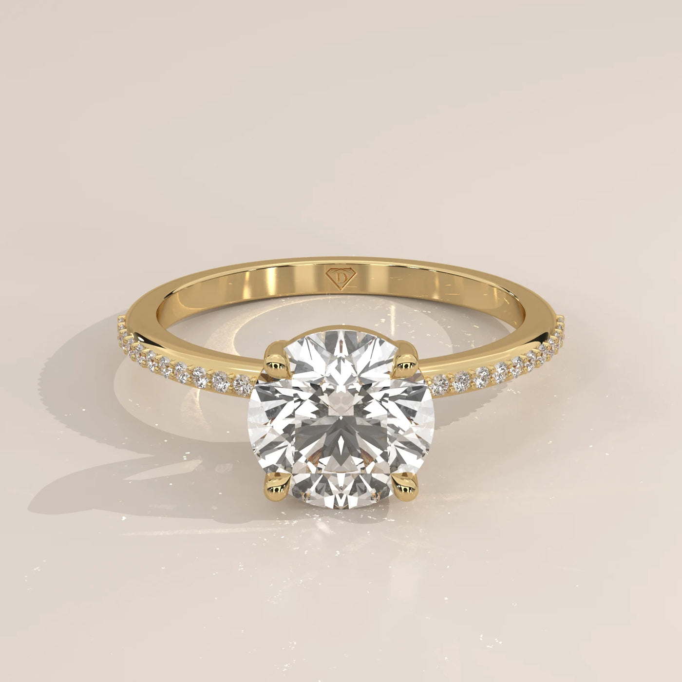A classic 14k yellow gold solitaire engagement ring with pave diamonds on the band.