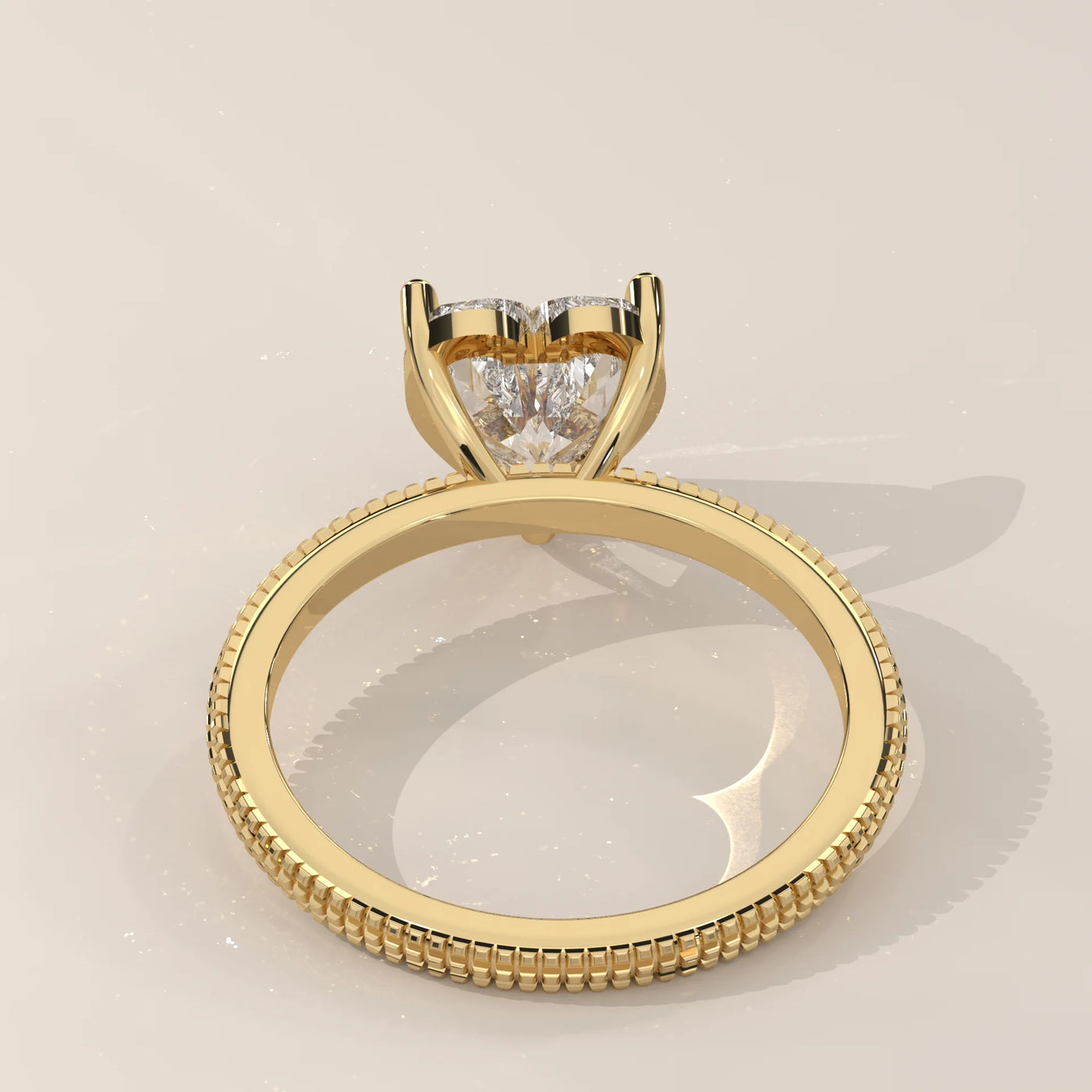 A classic solitaire diamond ring in 14k yellow gold with pavé band details.