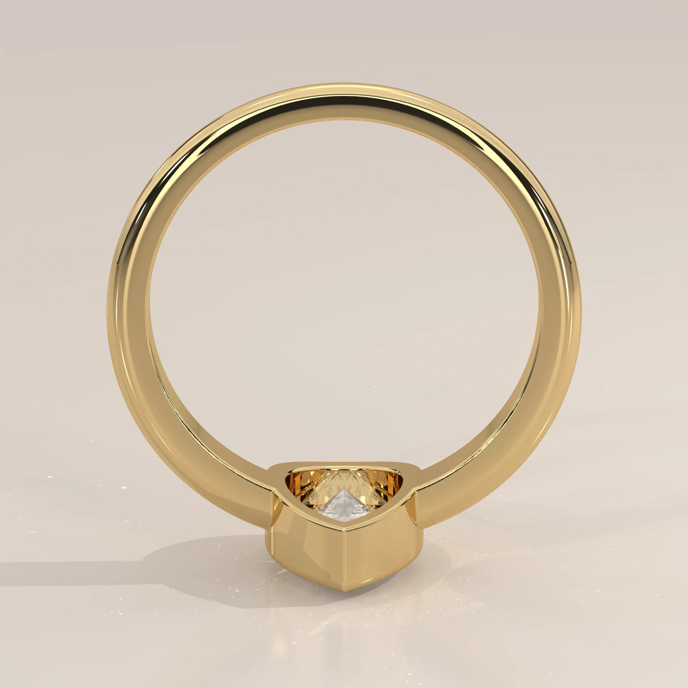 A simple yellow gold ring with a solitaire diamond.