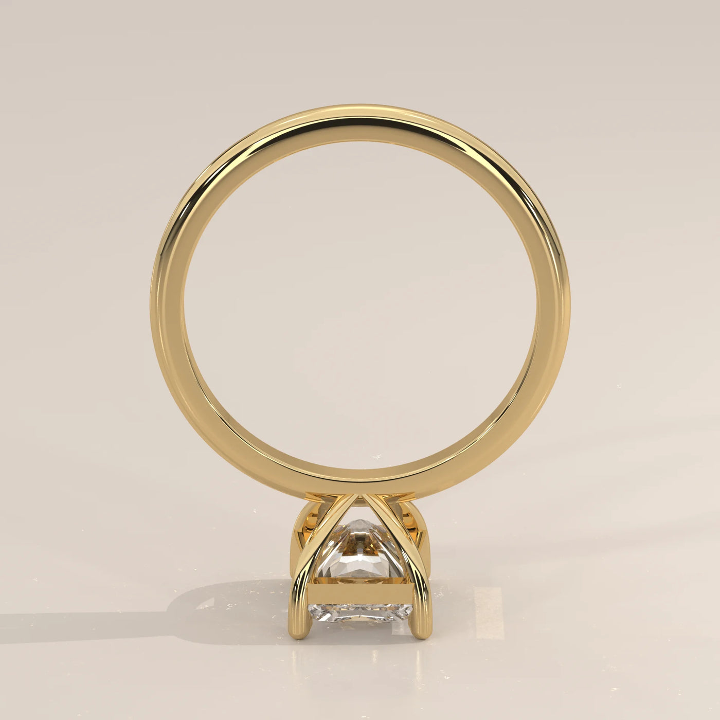A square-cut diamond engagement ring in yellow gold, shown from the side.