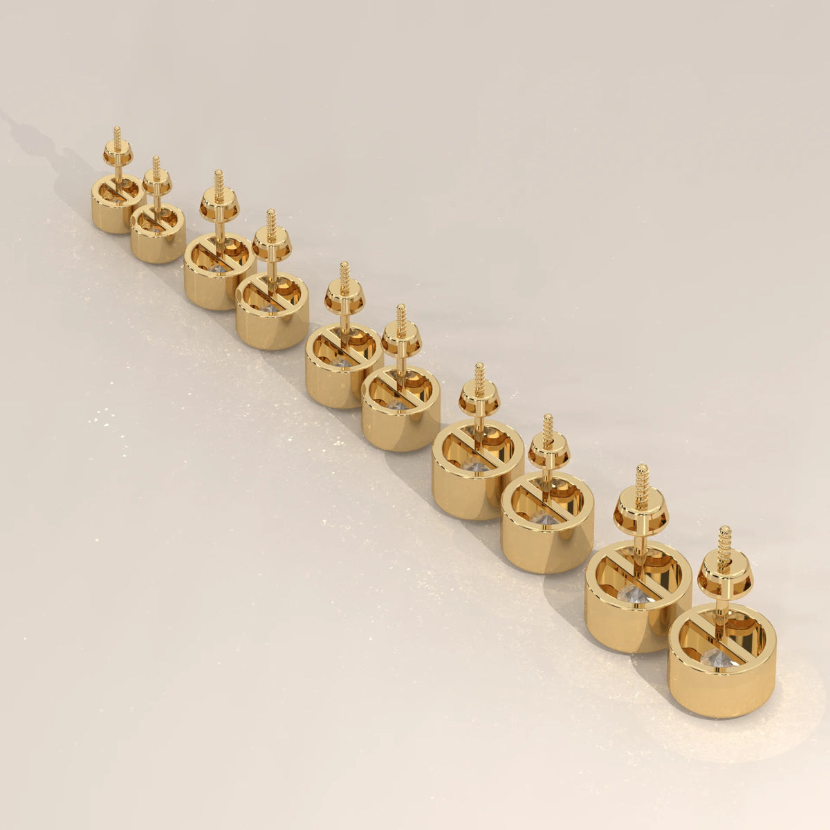 A line of small, round gold stud earrings with diamonds.