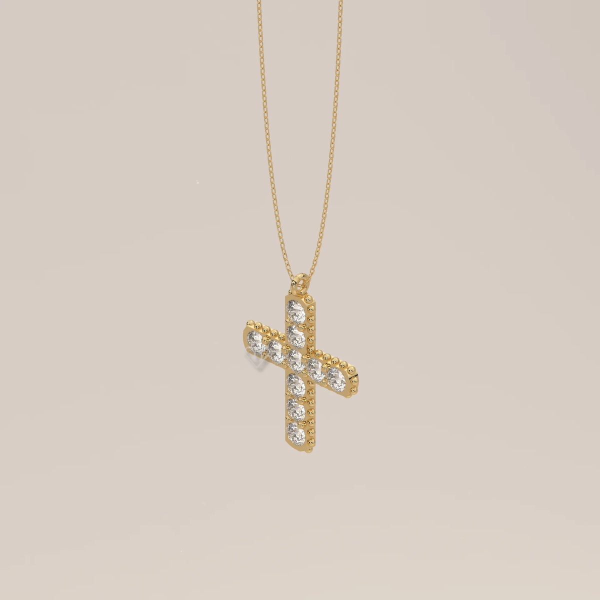 Round Lab Grown Diamond Cross Pendant with Beaded Edge in yellow gold, shown at an angle.