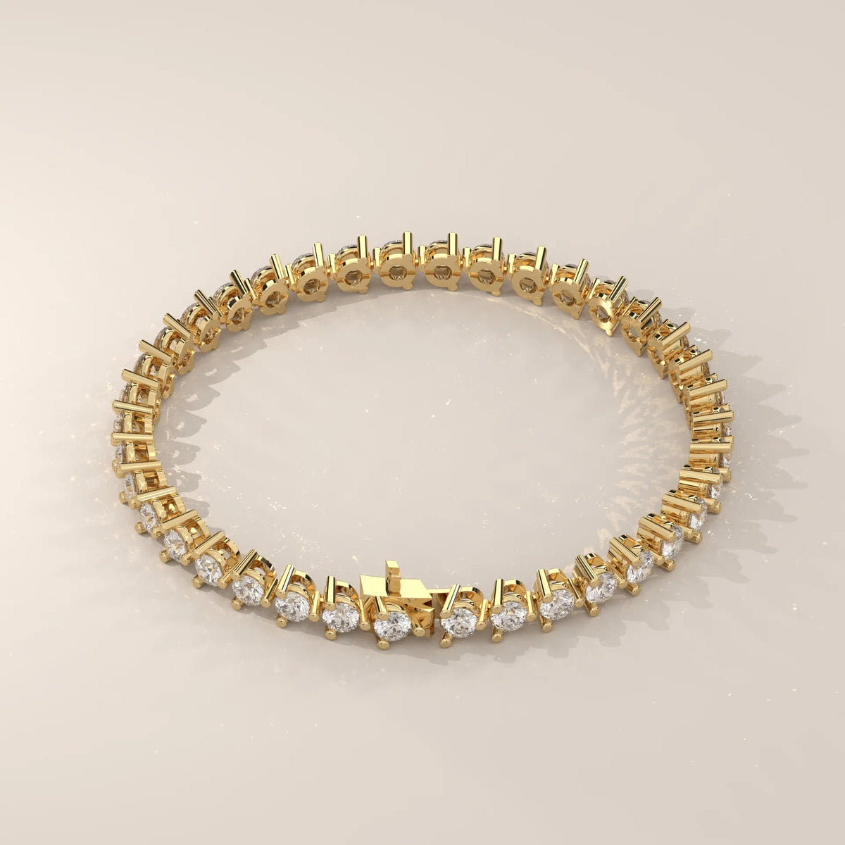 Round Lab Grown Diamond Tennis Bracelet in Three Prong Settings in yellow gold, product photograph on a plain background.