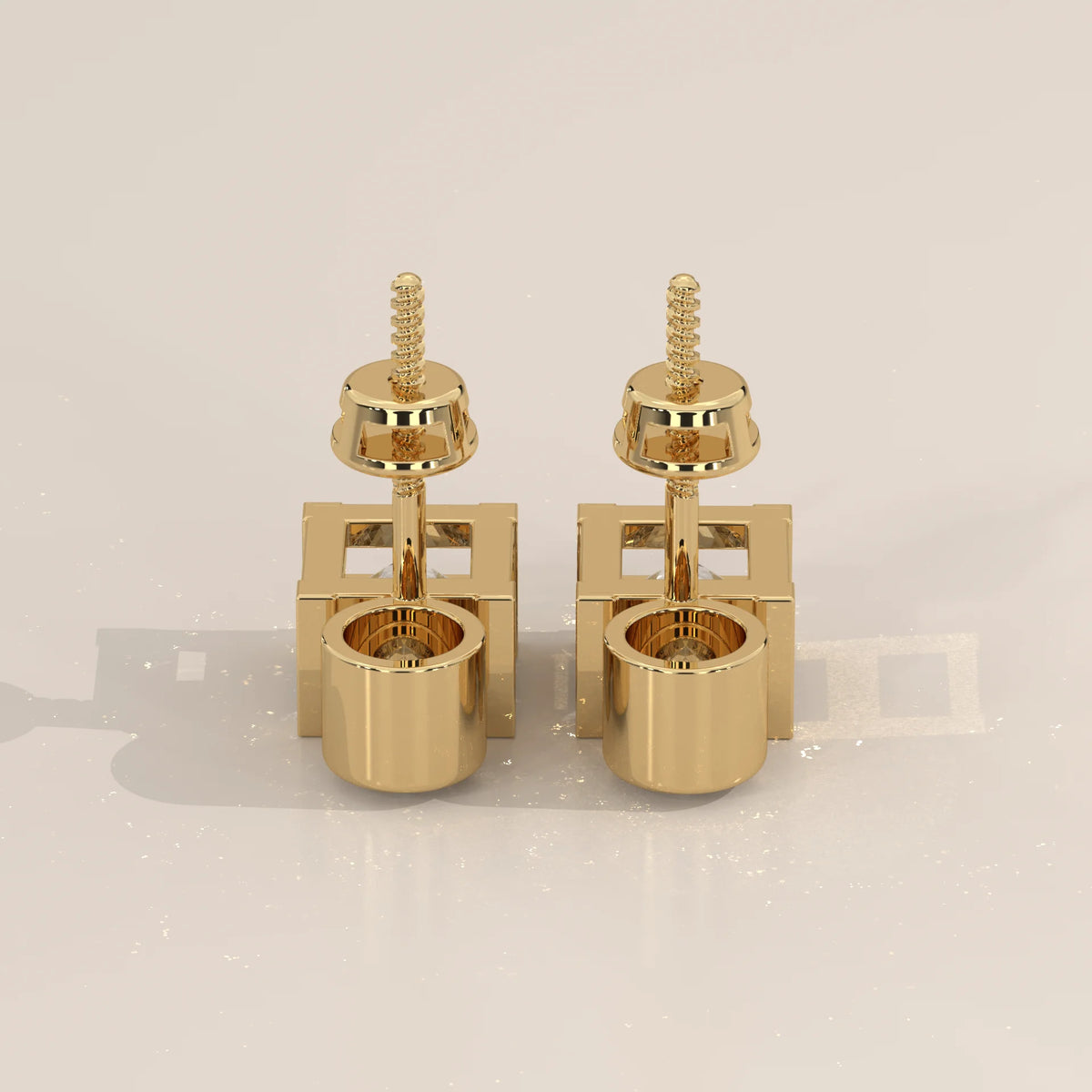 Round and Princess Two Stone Lab Grown Diamond Stud Earrings in yellow gold, studio photograph on a plain background.