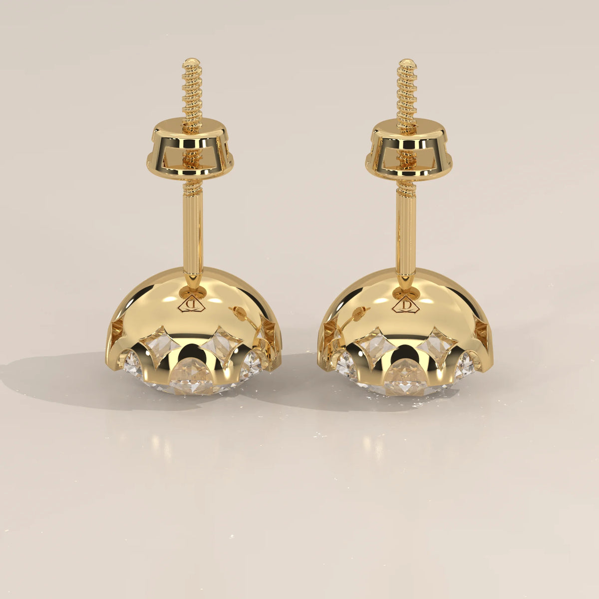 Round Solitaire Lab Grown Diamond Studs in a Crown Setting in yellow gold, product photograph on a plain background.