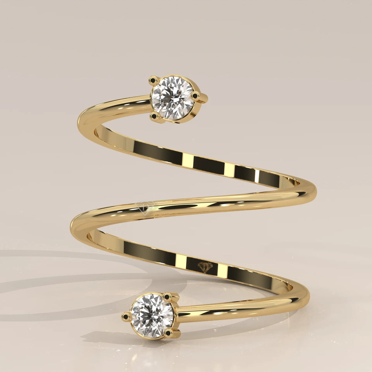 Round Lab Grown Diamond Spiral Wrap Ring with Two Claw Set Ends in yellow gold, studio photograph on a plain background.