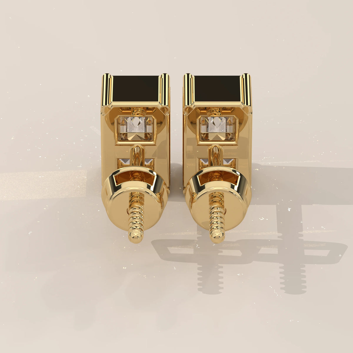 A pair of 14k gold square stud earrings with diamonds and black onyx.