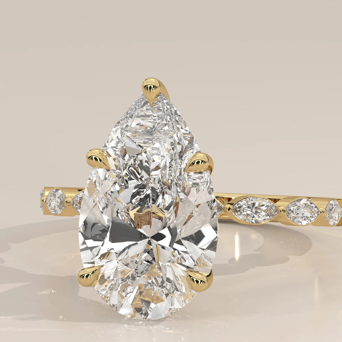 Stlea 5 Carat Pear Lab Grown Diamond Ring, Bezel Marquise Band in yellow gold, product photograph on a plain background.