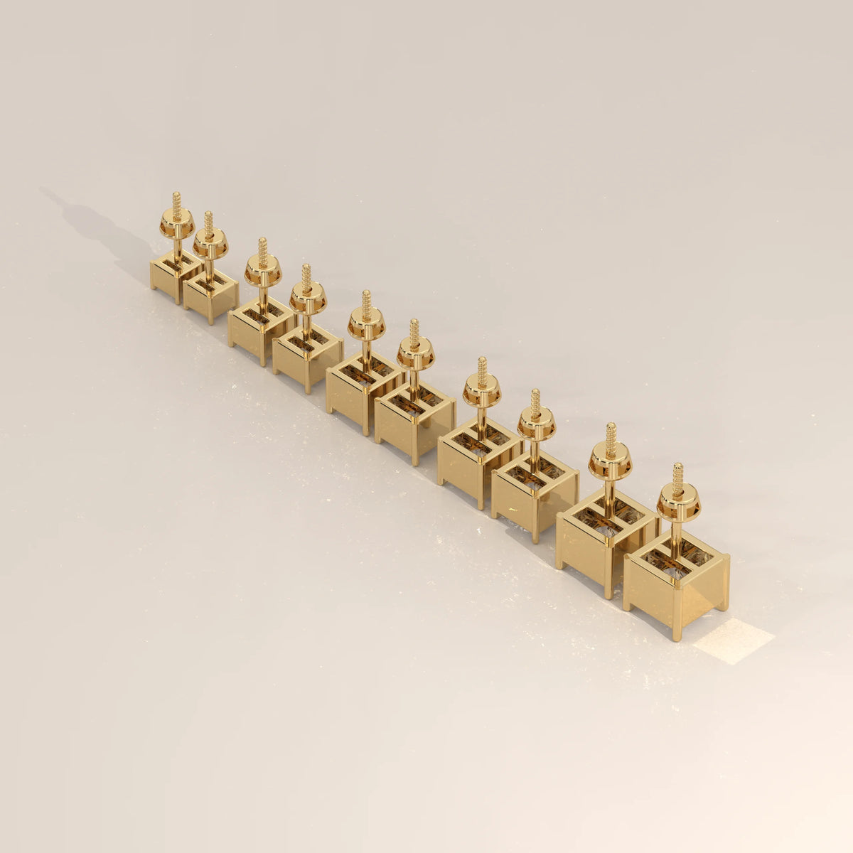 A row of ten yellow gold stud earrings with square bases.