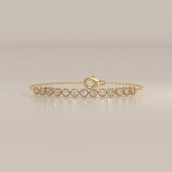 A delicate 14k gold bracelet featuring a line of round, brilliant-cut diamonds.