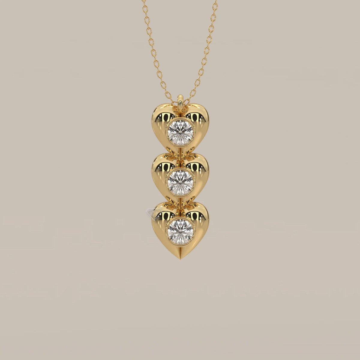 Three Puffed Heart Lab Grown Diamond Drop Pendant with Bezel Rounds in yellow gold, front view on a plain background.