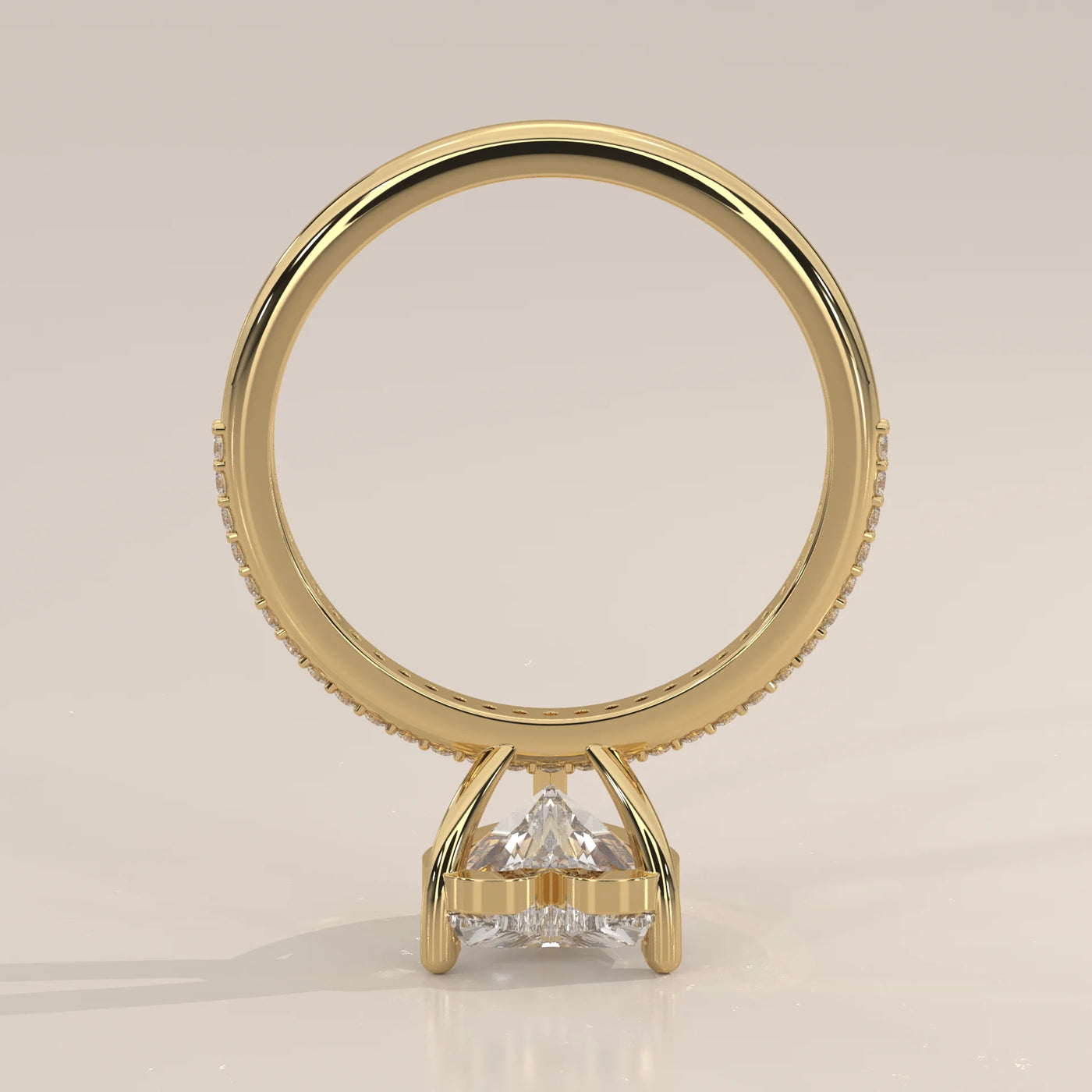 Gold ring with a trillion-cut diamond and pave band.