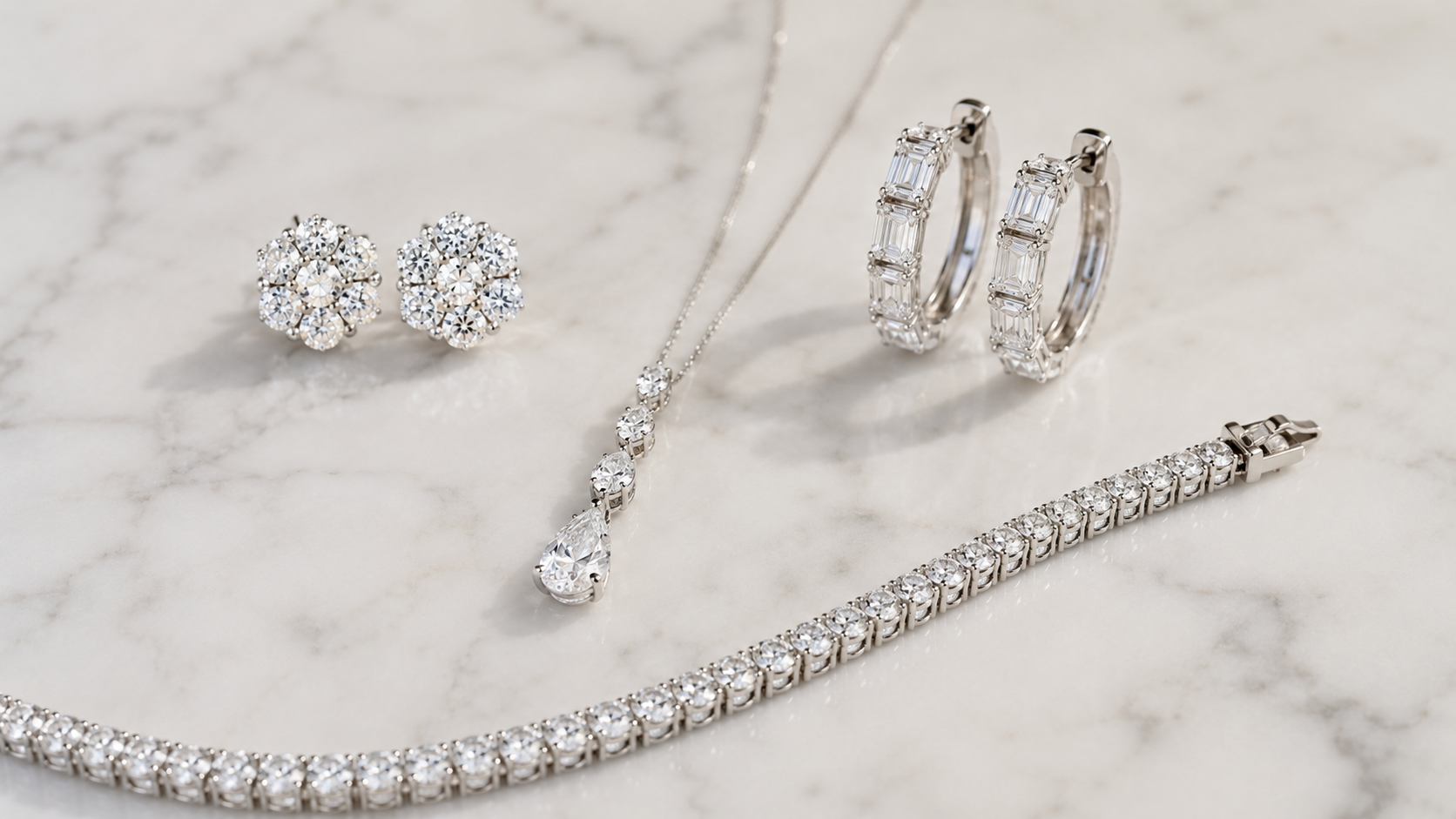 Lab grown diamond jewelry collection for milestone birthdays — earrings, bracelet, and ring on marble