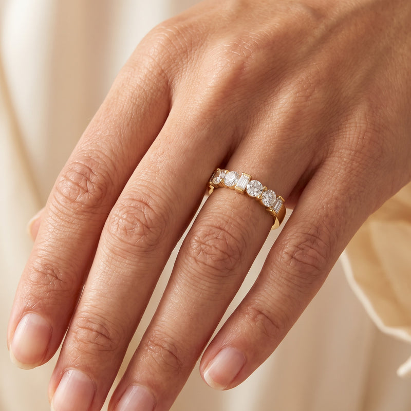 Anniversary band with alternating round and baguette diamonds in yellow gold