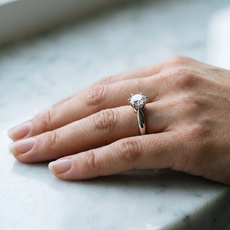 Classic round diamond solitaire in a white gold cathedral setting