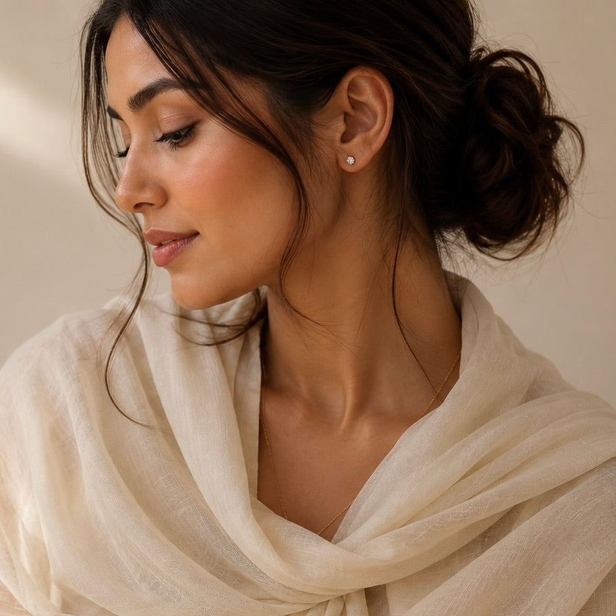 Woman wearing a beige scarf with a neutral background
