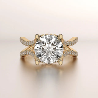 Yellow gold engagement ring with a large round center diamond and split pavé diamond bands.
