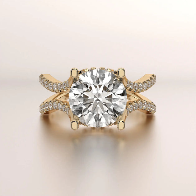 Yellow gold engagement ring with a large round center diamond and split pavé diamond bands.