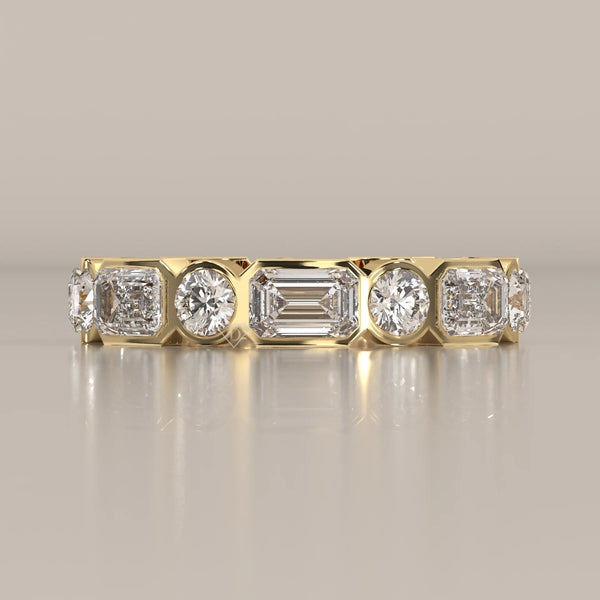 Emerald and Round Lab Grown Diamond Bezel Set Eternity Band in yellow gold, shown from the front.