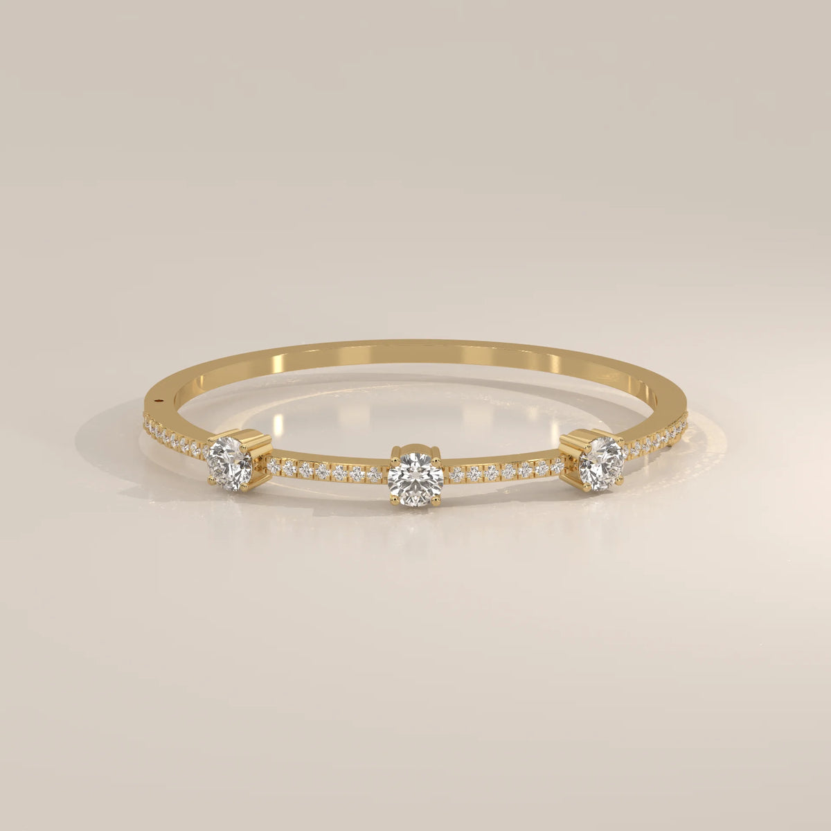 A delicate 18k gold bangle bracelet adorned with diamonds.
