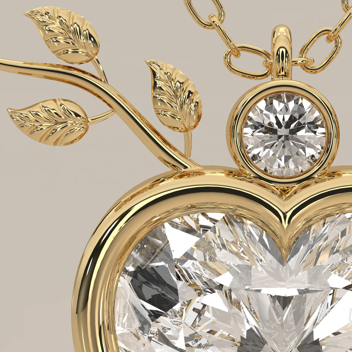 Bezel Heart Lab Grown Diamond Pendant with Leafy Branch Crown in yellow gold, product photograph on a plain background.