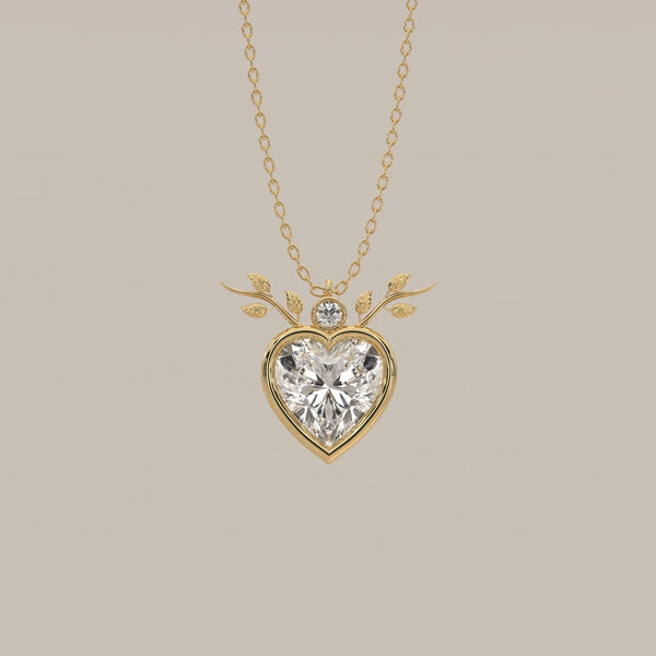 Bezel Heart Lab Grown Diamond Pendant with Leafy Branch Crown in yellow gold, shown from the front.