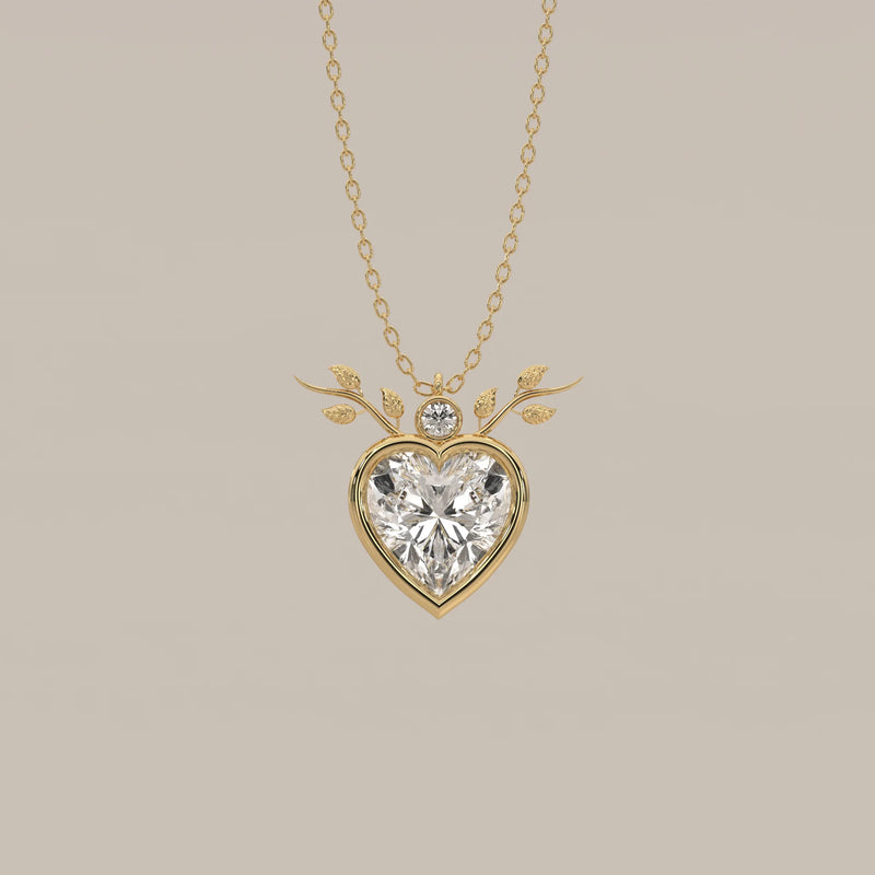 Bezel Heart Lab Grown Diamond Pendant with Leafy Branch Crown in yellow gold, shown from the front.