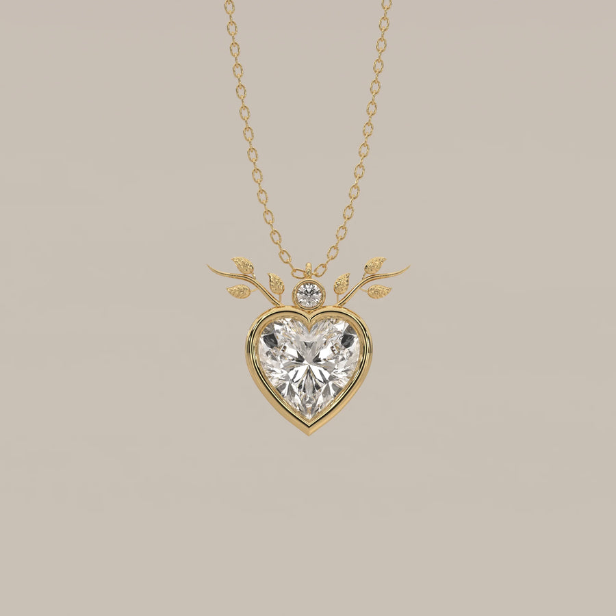 Bezel Heart Lab Grown Diamond Pendant with Leafy Branch Crown in yellow gold, shown from the front.