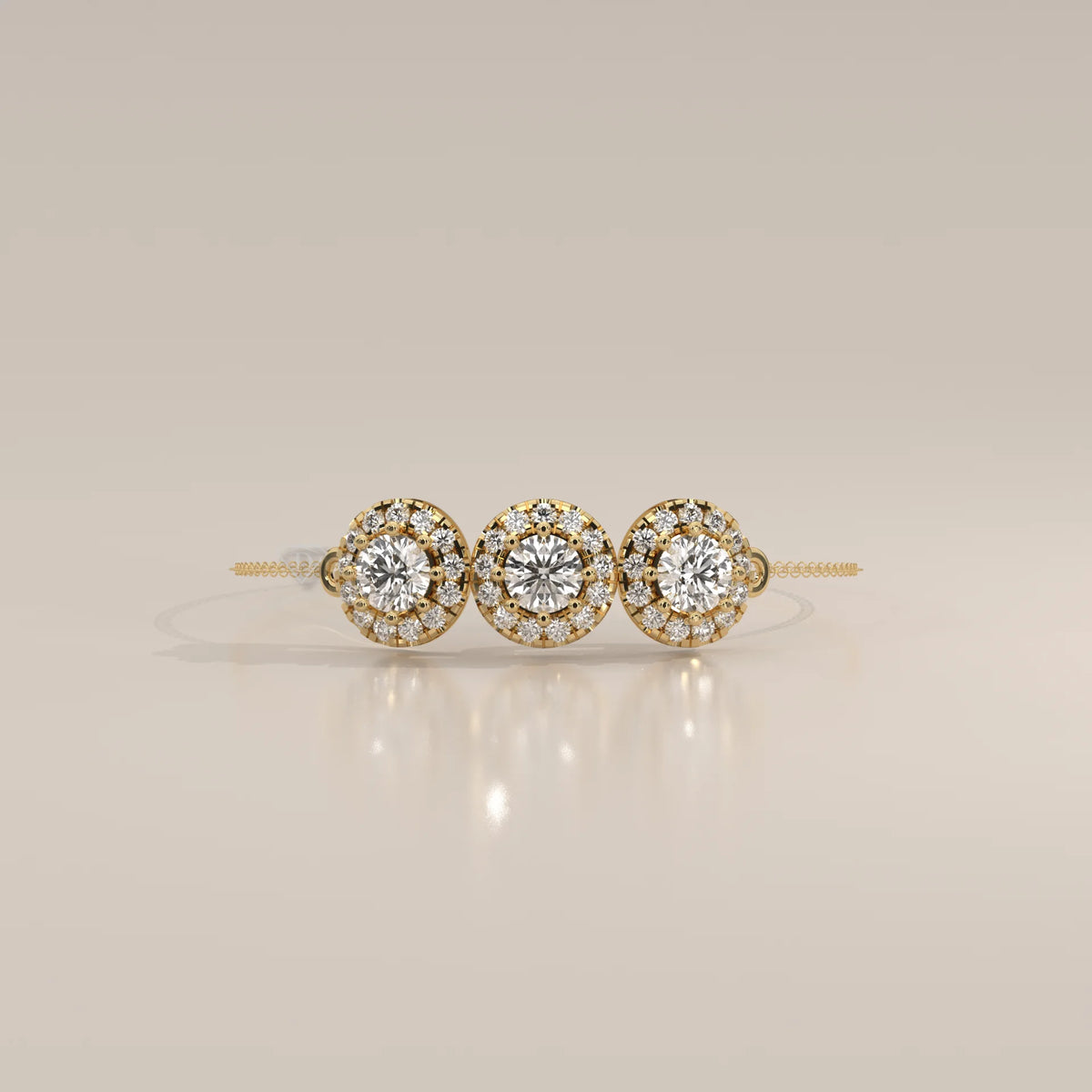 Delicate 14k gold bracelet with three round diamond clusters.