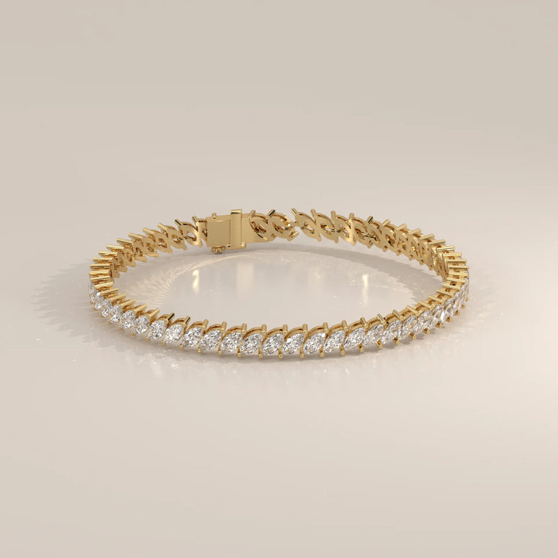 A yellow gold bracelet adorned with marquise-cut diamonds.
