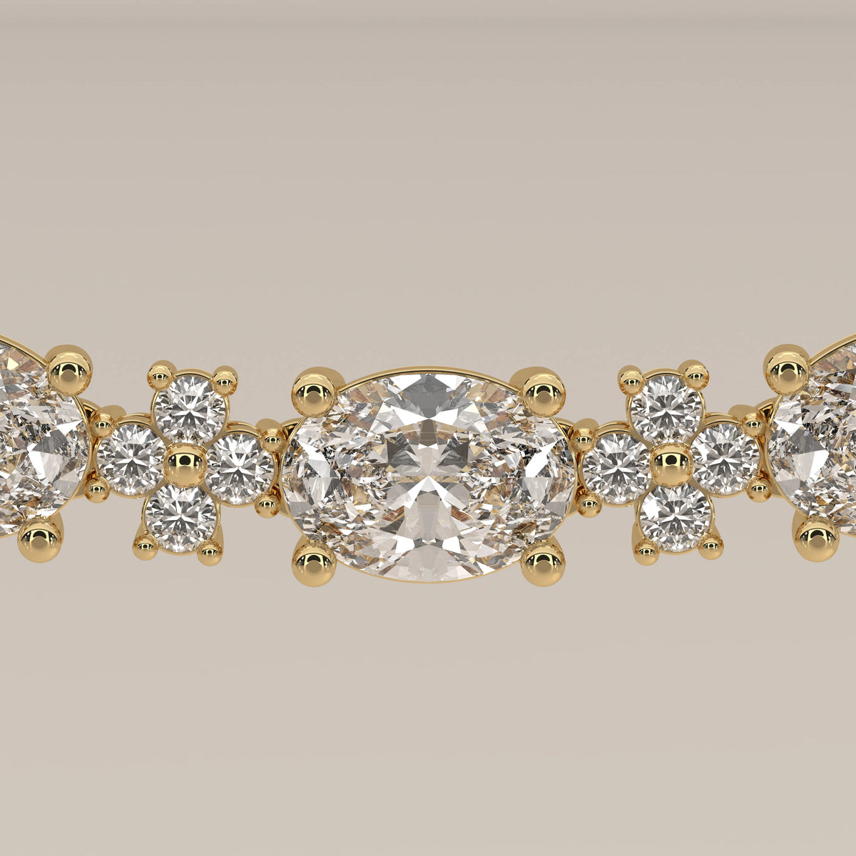 A graduated oval lab grown diamond necklace in yellow gold, viewed from above.