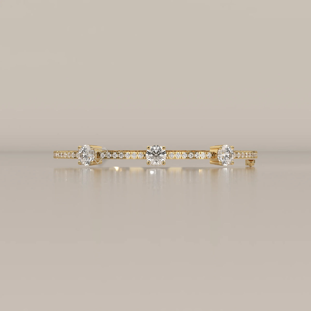 A thin gold bracelet with three diamonds and small accent stones