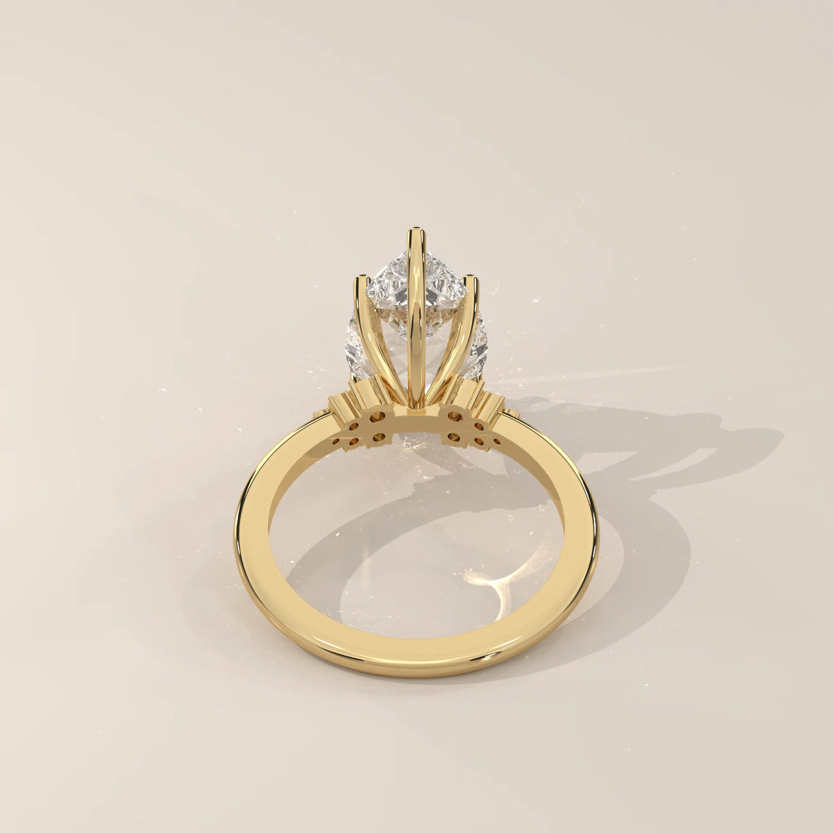 Bronze 5 Carat Pear Lab Grown Diamond Ring, Cluster Shoulders in yellow gold, shown on a plain background.