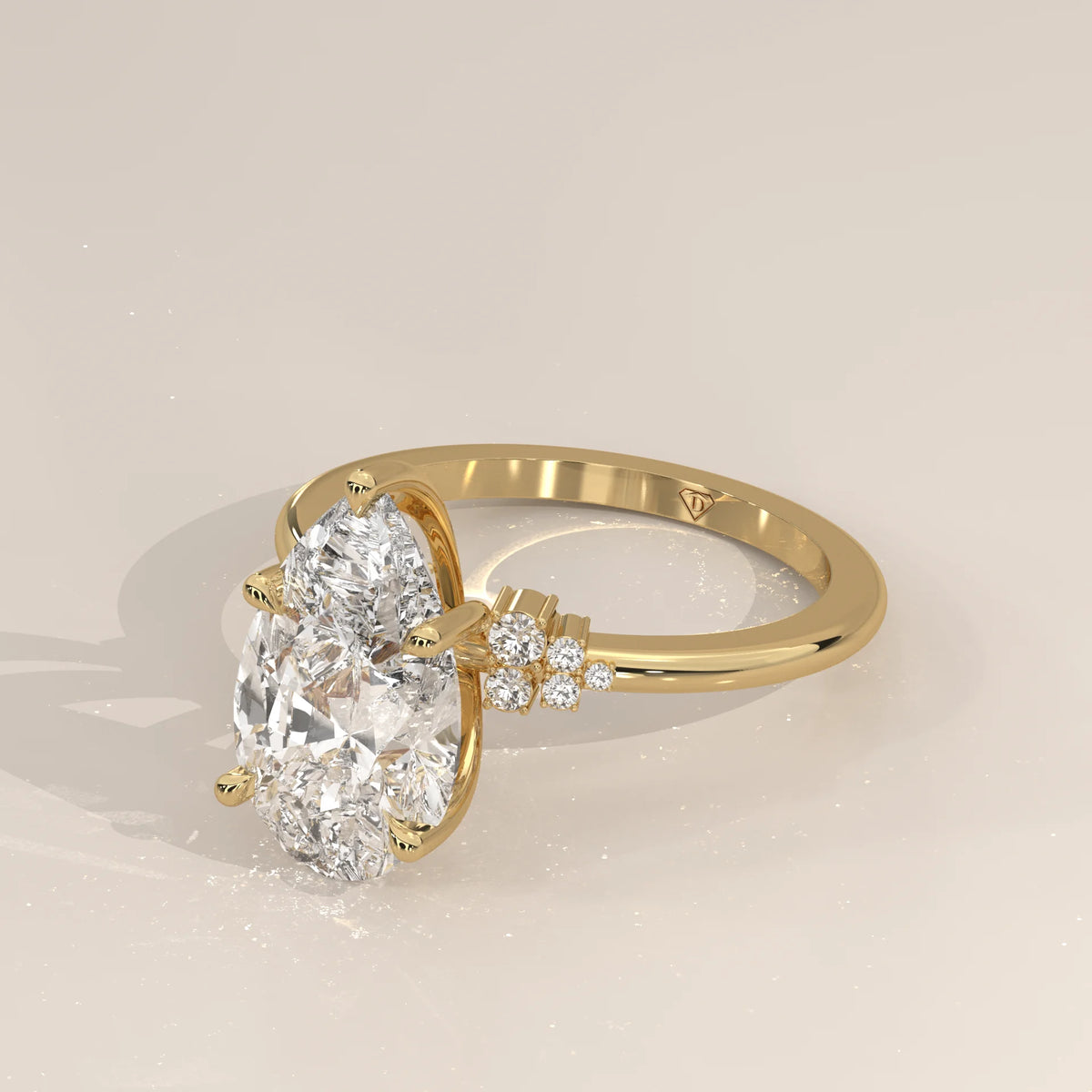 Bronze 5 Carat Pear Lab Grown Diamond Ring, Cluster Shoulders in yellow gold, shown from the side.