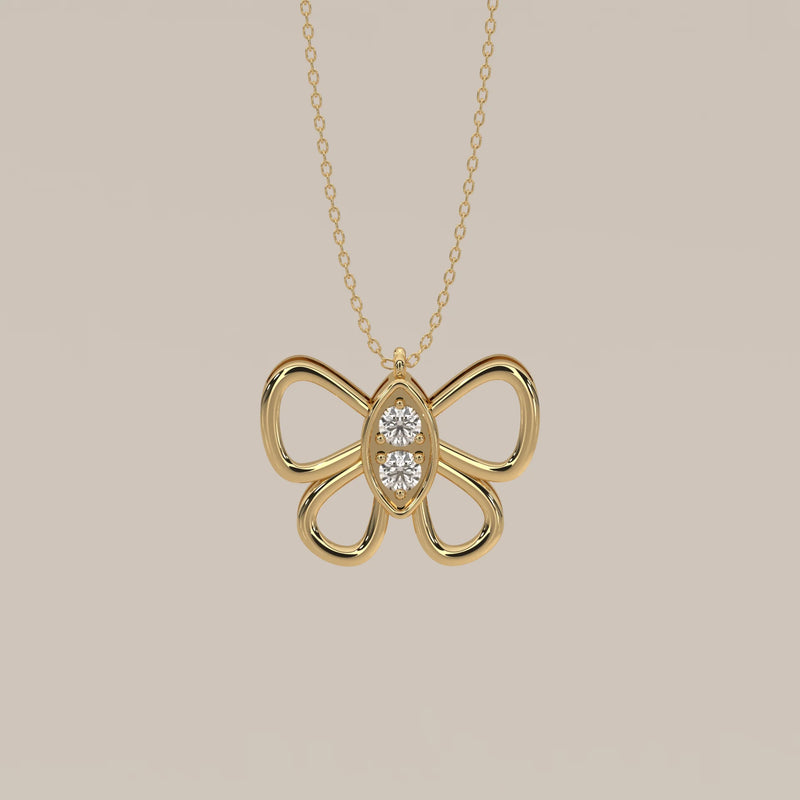 A delicate 14k gold necklace with a butterfly pendant adorned with two diamonds.