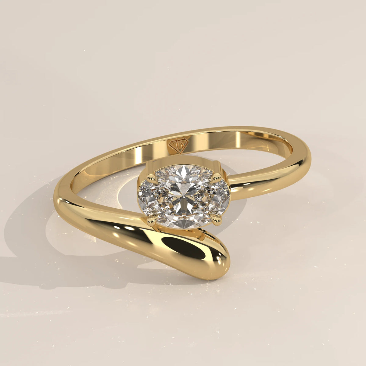 East West Oval Lab Grown Diamond Bypass Ring with Teardrop End in yellow gold, shown at an angle.
