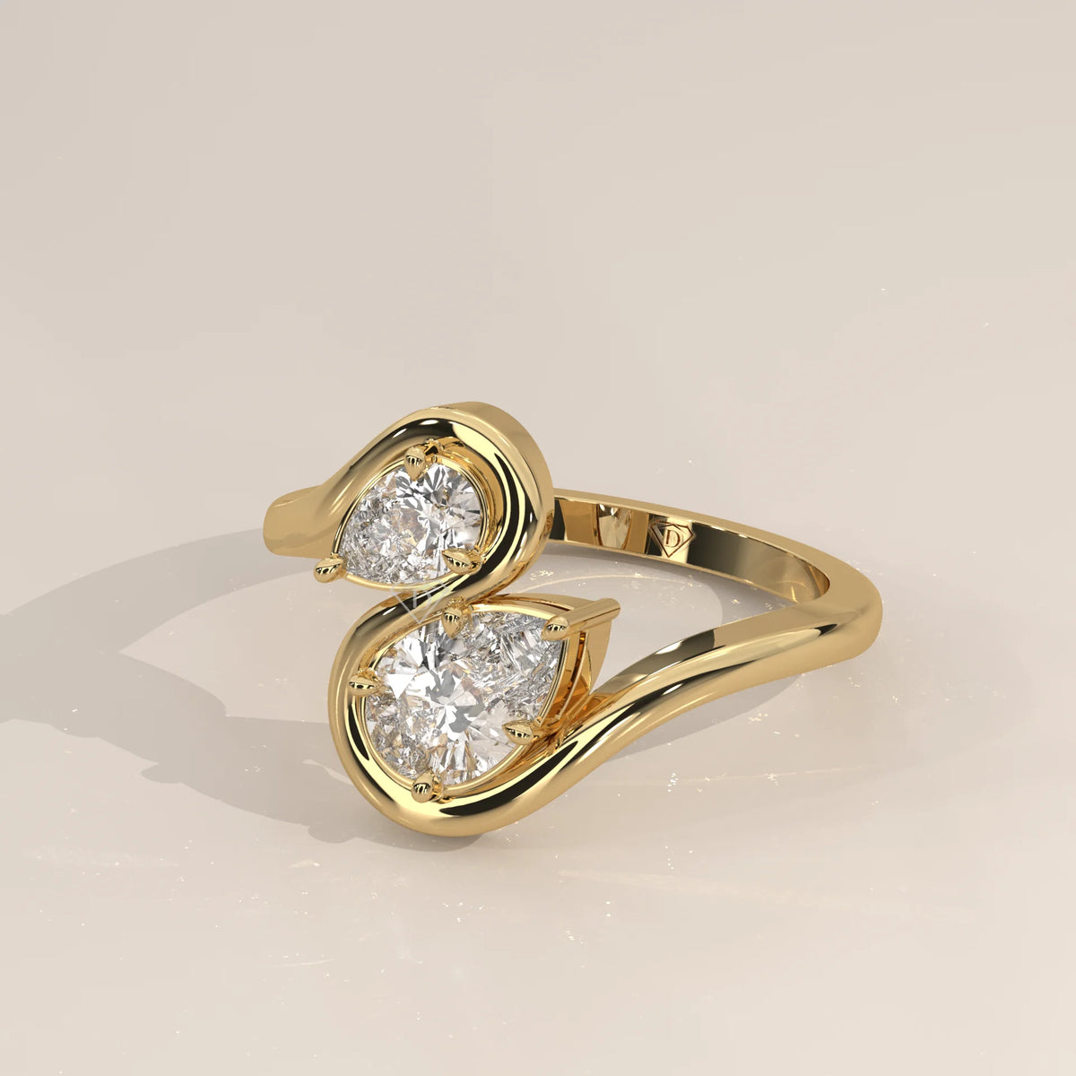 Two Pear Lab Grown Diamond Toi et Moi Ring with S Shaped Outline in yellow gold, shown at an angle.