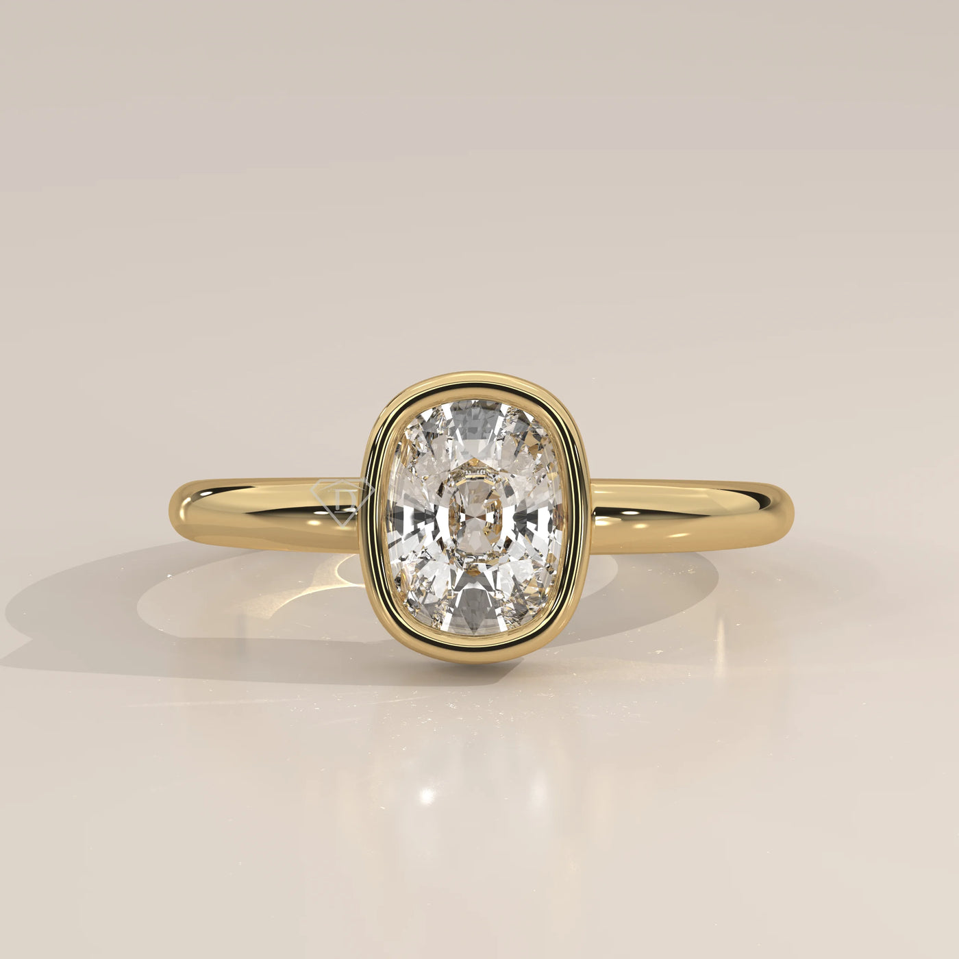 A yellow gold ring with a bezel-set cushion-cut diamond.