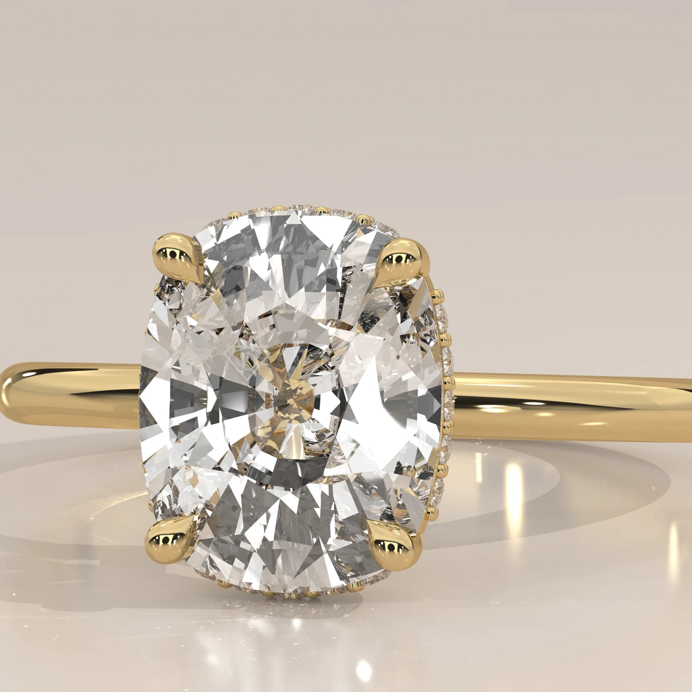 A cushion-cut diamond engagement ring in 14k yellow gold.